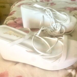 White sandals on platform with long straps